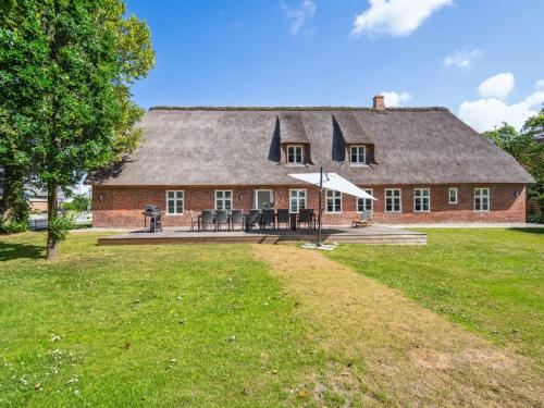 a large red brick house with a roof at Holiday Home Thordis by Interhome in Højer