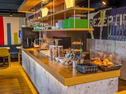 a kitchen with a counter with food on it at B&B HOTEL Koblenz-Nord in Mülheim-Kärlich
