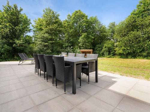 a black table and chairs on a patio at Holiday Home Kiro - 3km from the sea by Interhome in Toftlund