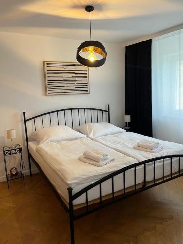 a bedroom with a large bed with a black frame at In City by IQ Apartments in Prešov