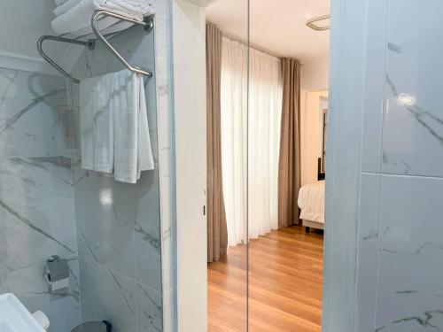 a bathroom with a shower with a glass door at niXie Hotel Bodrum in Bodrum City