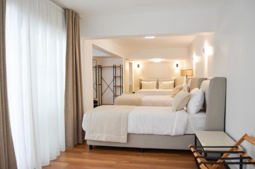 a bedroom with a large bed with white sheets at niXie Hotel Bodrum in Bodrum City