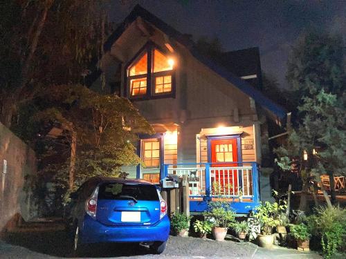 a car parked in front of a house at night at Top Hill woman only accommodation in Wada