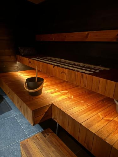 a wooden bench with a bowl on top of it at Aava Riverside in Rovaniemi