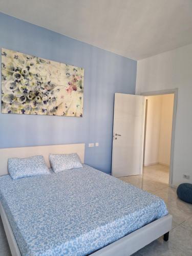 a bedroom with a bed and a painting on the wall at House 13 apartment in Cernobbio in Cernobbio