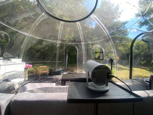 a hair dryer on a table in front of a glass house at Skyhome Bubble Hotel in Prague
