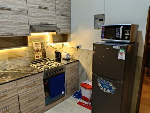 a kitchen with a stove and a refrigerator at Modern Stand alone estate house in Mombasa