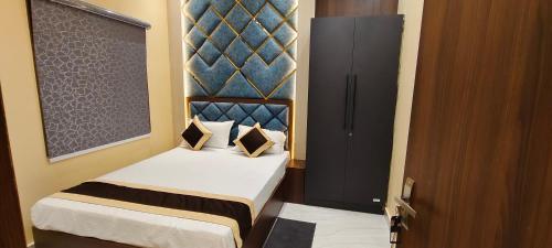 a small bedroom with a bed and a door at Hotel Bodhi Heritage And Restaurant in Gaya