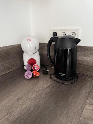 a black coffee maker and a blender on a counter at Smile home, Zaanse schans and Amsterdam Appartements in Wormerveer