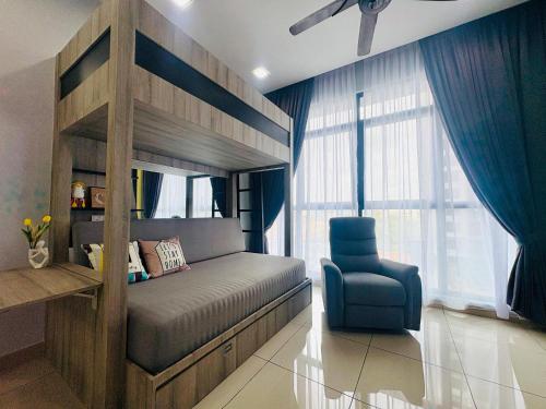 a bedroom with a bunk bed and a blue chair at Group-Friendly Stay in Putrajaya & IOI City Mall in Putrajaya