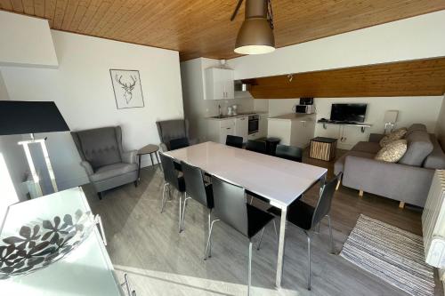 a kitchen and living room with a table and chairs at Vars at the foot of the slopes - apartment for 6 people in Vars