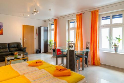 a living room with a bed and a table at Hotel Am Müritzhafen garni in Waren
