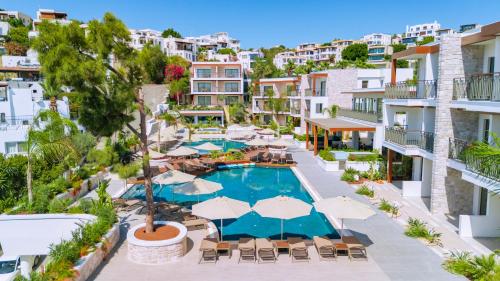 an aerial view of a resort pool with umbrellas at Ayaz Suites in Bodrum City