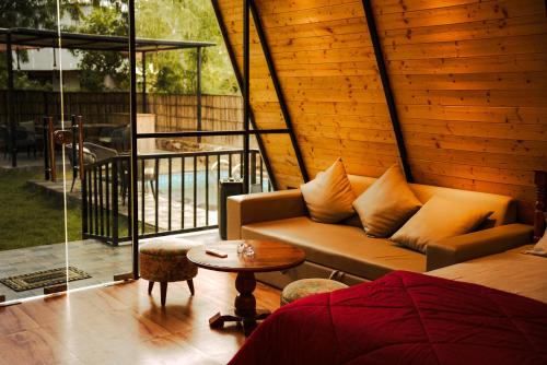 a living room with a couch and a table at Dunewood villa in Jaipur