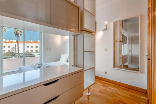 a bathroom with a sink and a mirror at Lux Apt in Priv Condo with Pool, near Beach, Parking & Easy Access to Lisbon in Parede