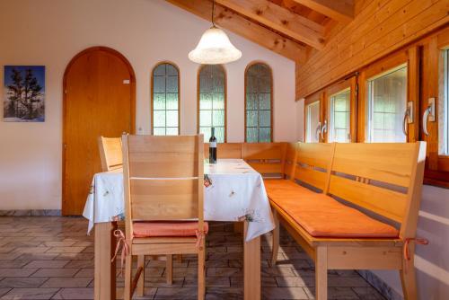 a dining room with a wooden table and chairs at Chalet Pantke in Lax