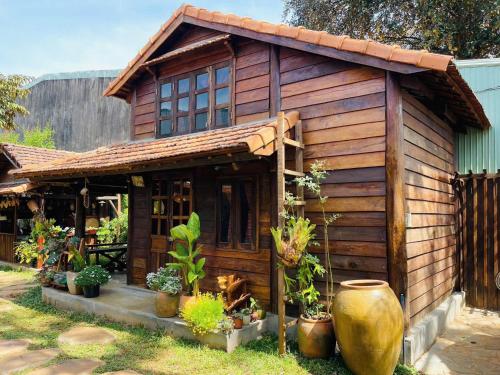 a small wooden house with plants in front of it at Ôna's House - Homestay Pleiku in Pleiku
