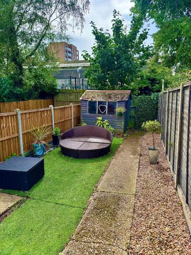 a small garden with a boat in the grass at Stylish & modern 2 bedroom City Centre Norwich Home in Norwich