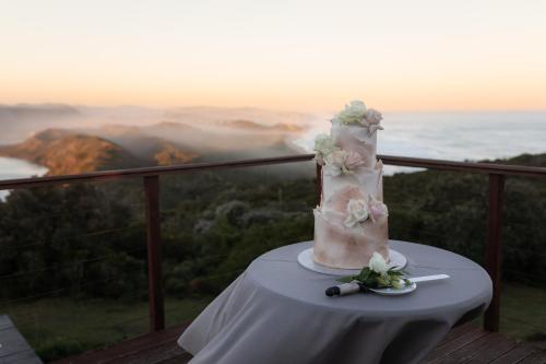 a wedding cake sitting on a table on a balcony at Simbavati Fynbos on Sea in Sedgefield