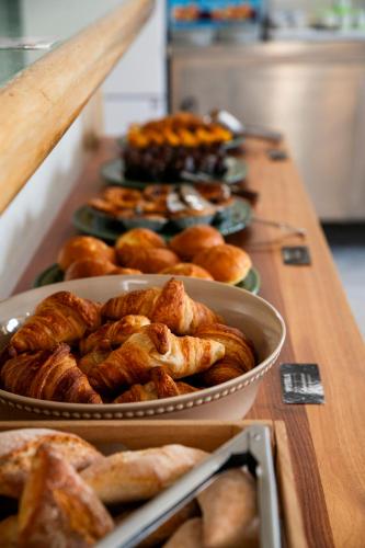 a table with trays of pastries and other pastries at WOT Algarve in Almancil