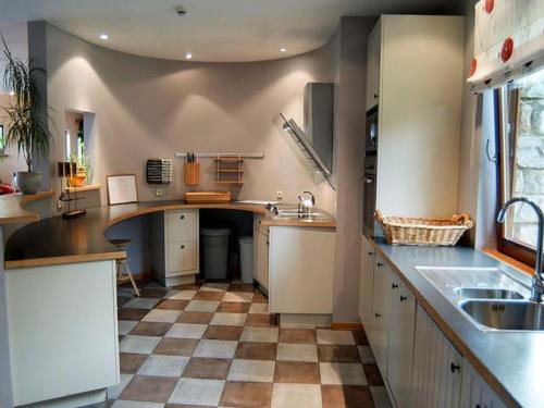 a large kitchen with a checkered floor at Large Home with Sauna, Ovifat in Ovifat