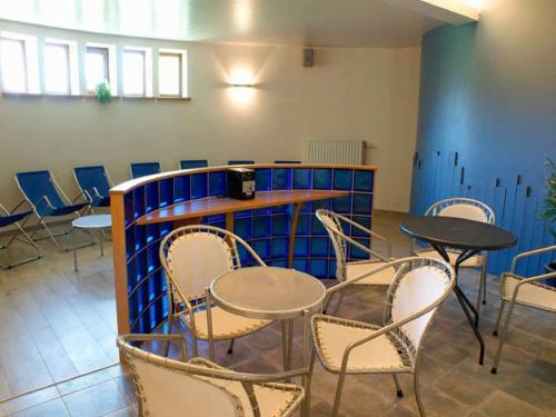 a room with chairs and tables and a table and chairs at Large Home with Sauna, Ovifat in Ovifat