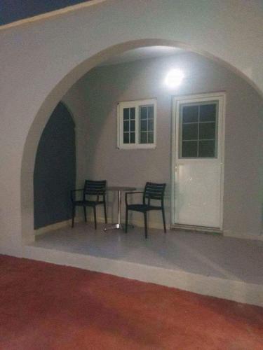 a dining room with two chairs and a table in a room at Platoni Elite in Ialyssos