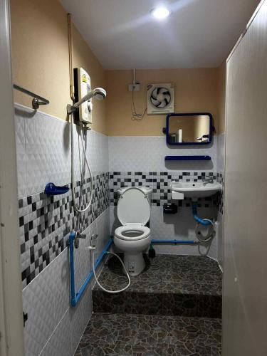 a bathroom with a toilet and a sink at Rattana's Resort in Ranong