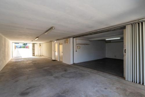 an empty room with an empty parking lot at Bright Flat with Balcony & Garage by HostWise in Oliveira do Douro
