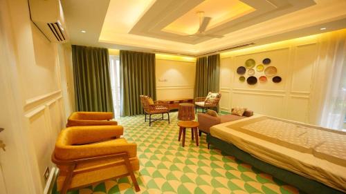 a hotel room with a bed and a table and chairs at Villa Paraiso by DanCenter | 4BHK Pvt Pool | Arpora in Goa