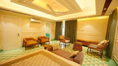 a living room with a couch and chairs at Villa Paraiso by DanCenter | 4BHK Pvt Pool | Arpora in Goa