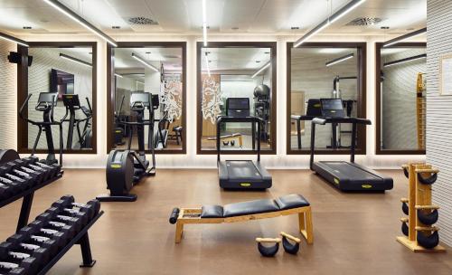 a gym with a bunch of treadmills and machines at ME Barcelona in Barcelona