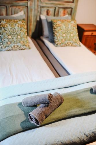 a pair of beds with a towel on the bed at Uroczysko Oleśnica in Chodzież