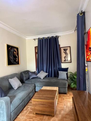 a living room with two couches and a coffee table at 2BD Apartment Near City Center Muyenga with Lake view in Kampala