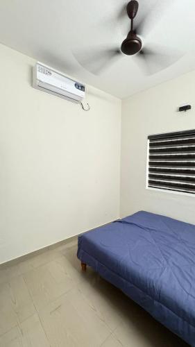a bedroom with a bed and a ceiling fan at Chandras appartment in Palakkad