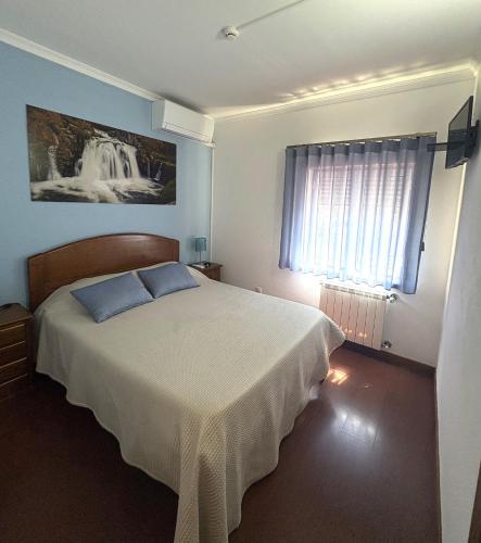a bedroom with a large bed and a window at Recanto do Açor in Vide
