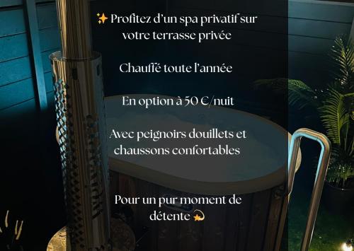 a sign in a window with a table and a chair at La Cachette du Domaine du Moulin avec son spa privé en option in Saint-Laurent-dʼAndenay