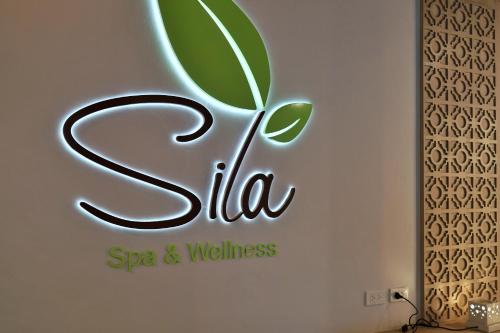 a spa and wellness sign on a wall at The Waters Khao Lak by Katathani - SHA Extra Plus in Khao Lak