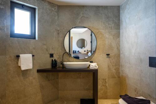 a bathroom with a sink and a mirror at Nalu Resort & SPA Adults Only Hotel in Adelianos Kampos