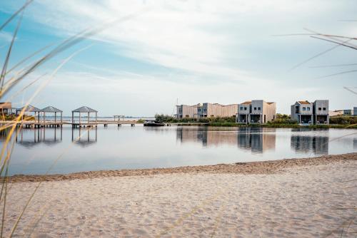 a body of water with houses and a dock at Studio Deluxe | 2 Pers. Landzijde in Ouddorp