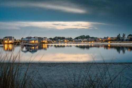 a view of a body of water with a town at Studio Deluxe | 2 Pers. Landzijde in Ouddorp