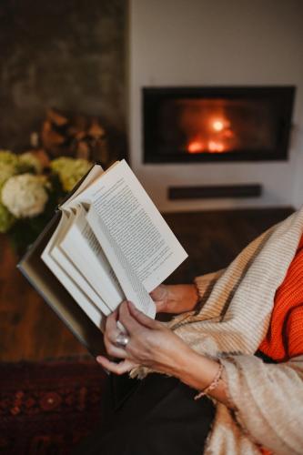 a woman is holding a book in her hands at Uroczysko Oleśnica in Chodzież