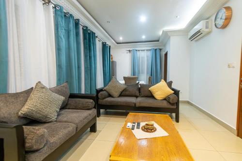 a living room with two couches and a coffee table at Citadin Apart Hotel Douala in Douala