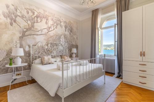 a bedroom with a bed and a wall mural at Villa Barbarano - villa privata con accesso al lago in Montecucco