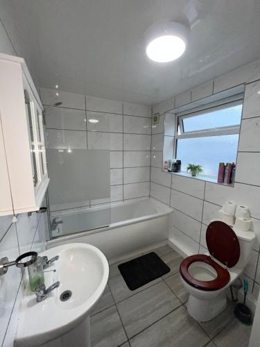 a bathroom with a tub and a toilet and a sink at Sky's City Centre Apartments next to St James Park in Newcastle upon Tyne