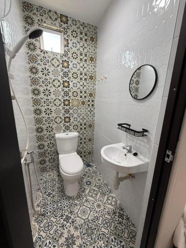 a bathroom with a toilet and a sink at AHM RoomSTAY in Kuala Terengganu