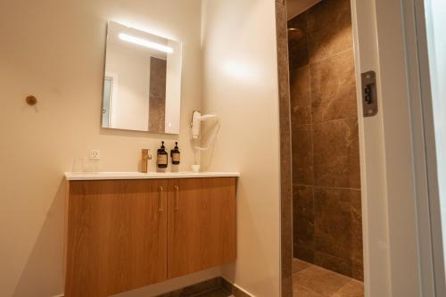 a bathroom with a sink and a shower at Arnbjerg Pavillonen in Varde