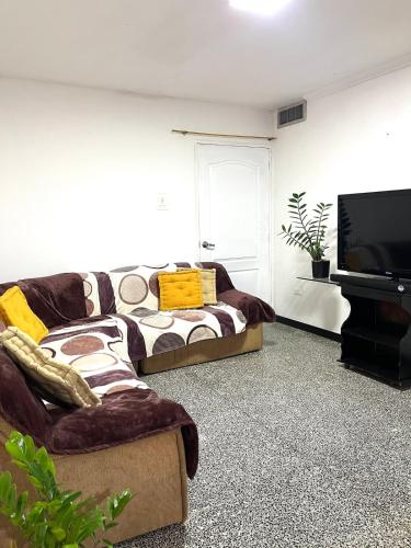 a living room with a couch and a flat screen tv at Comfort and an excellent area in Venezuela in Maracaibo