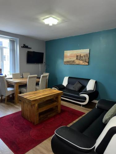 a living room with a couch and a table at Sky's City Centre Apartments next to St James Park in Newcastle upon Tyne