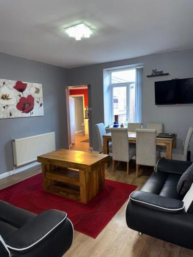 a living room with a couch and a table at Sky's City Centre Apartments next to St James Park in Newcastle upon Tyne